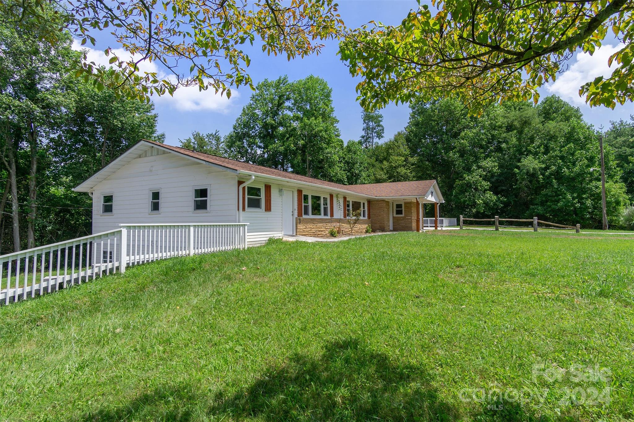 468 Deer Park Lake Road Spruce Pine, NC 28777 - Photo 23 of 46 a view of house with backyard and garden