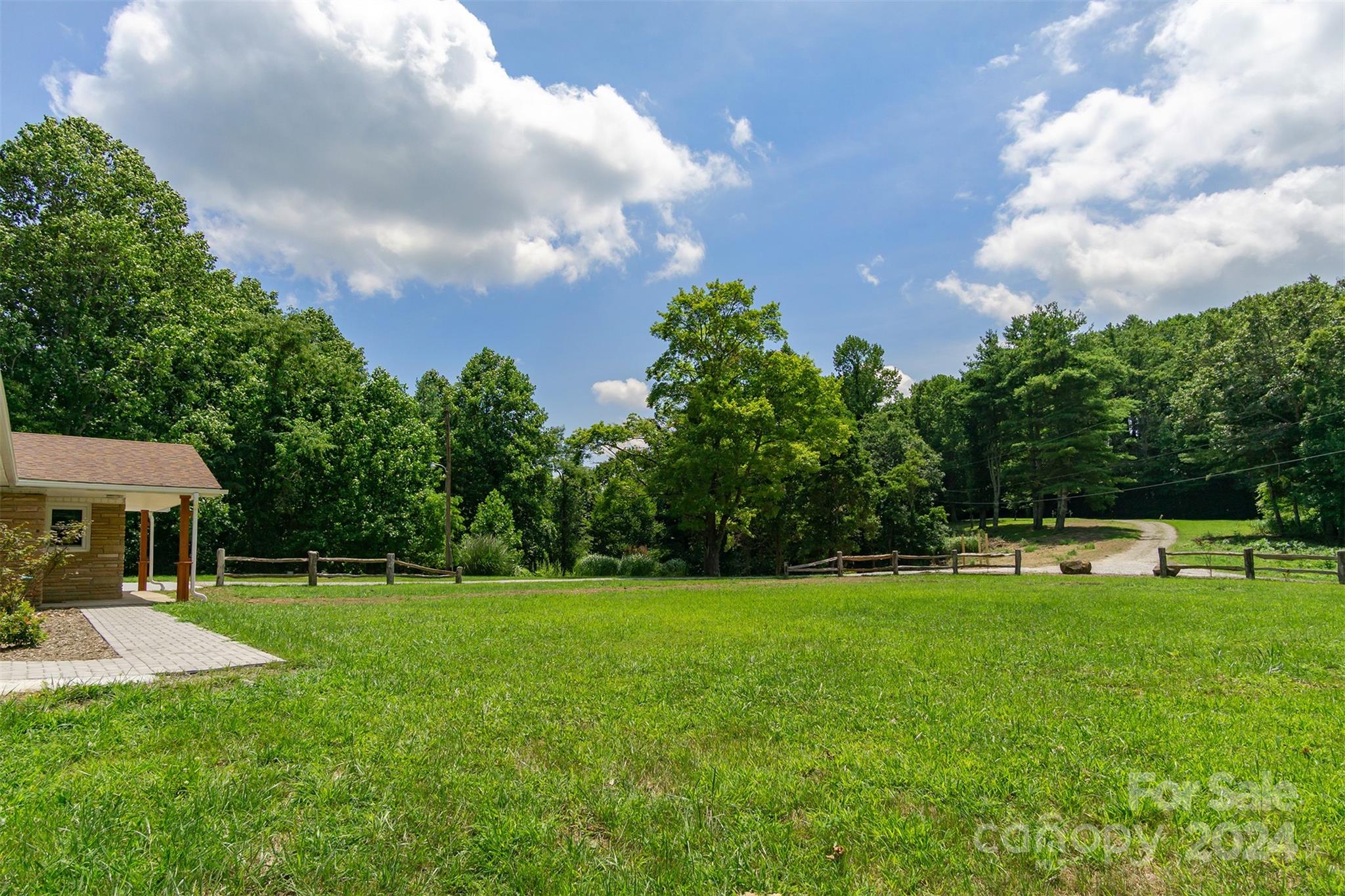 468 Deer Park Lake Road Spruce Pine, NC 28777 - Photo 24 of 46 a view of a house with a big yard and sitting area