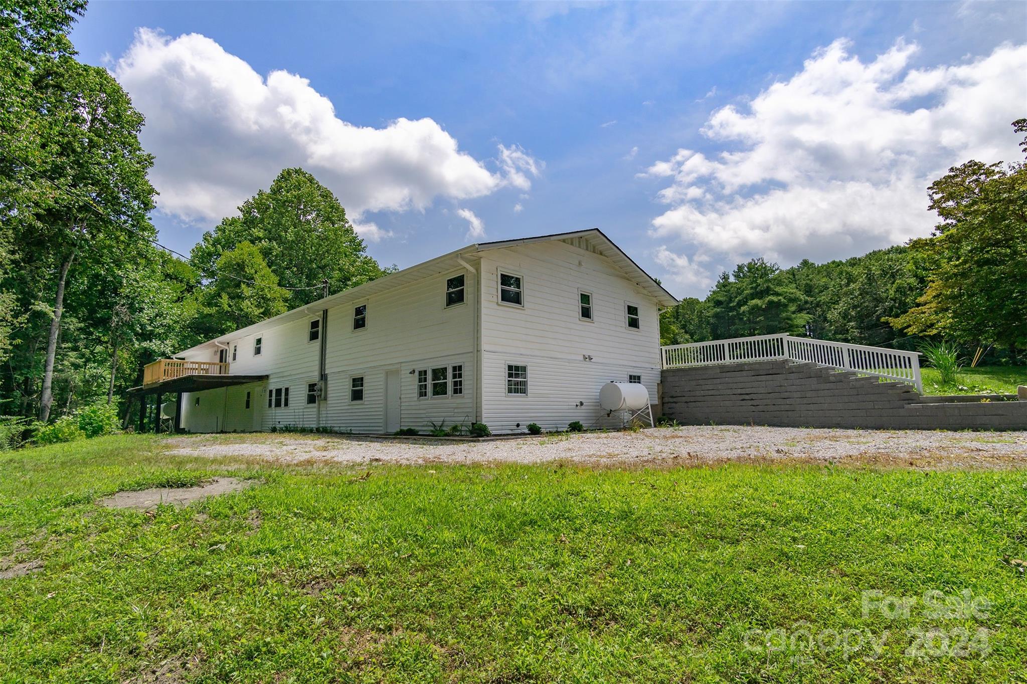 468 Deer Park Lake Road Spruce Pine, NC 28777 - Photo 27 of 46 a front view of a house with a yard and trees
