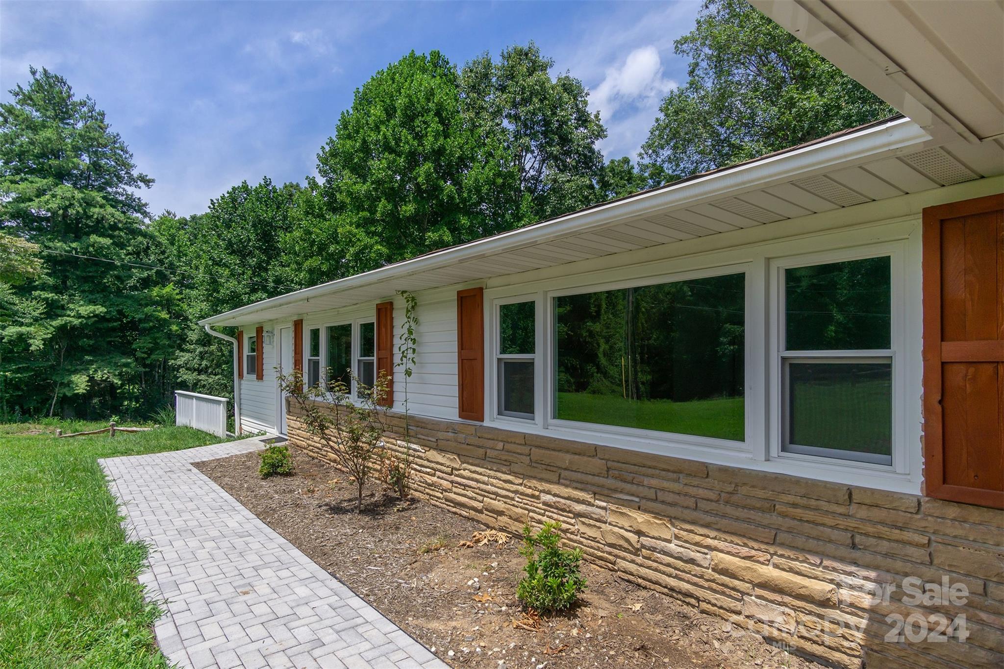 468 Deer Park Lake Road Spruce Pine, NC 28777 - Photo 32 of 46 a front view of a house with garden