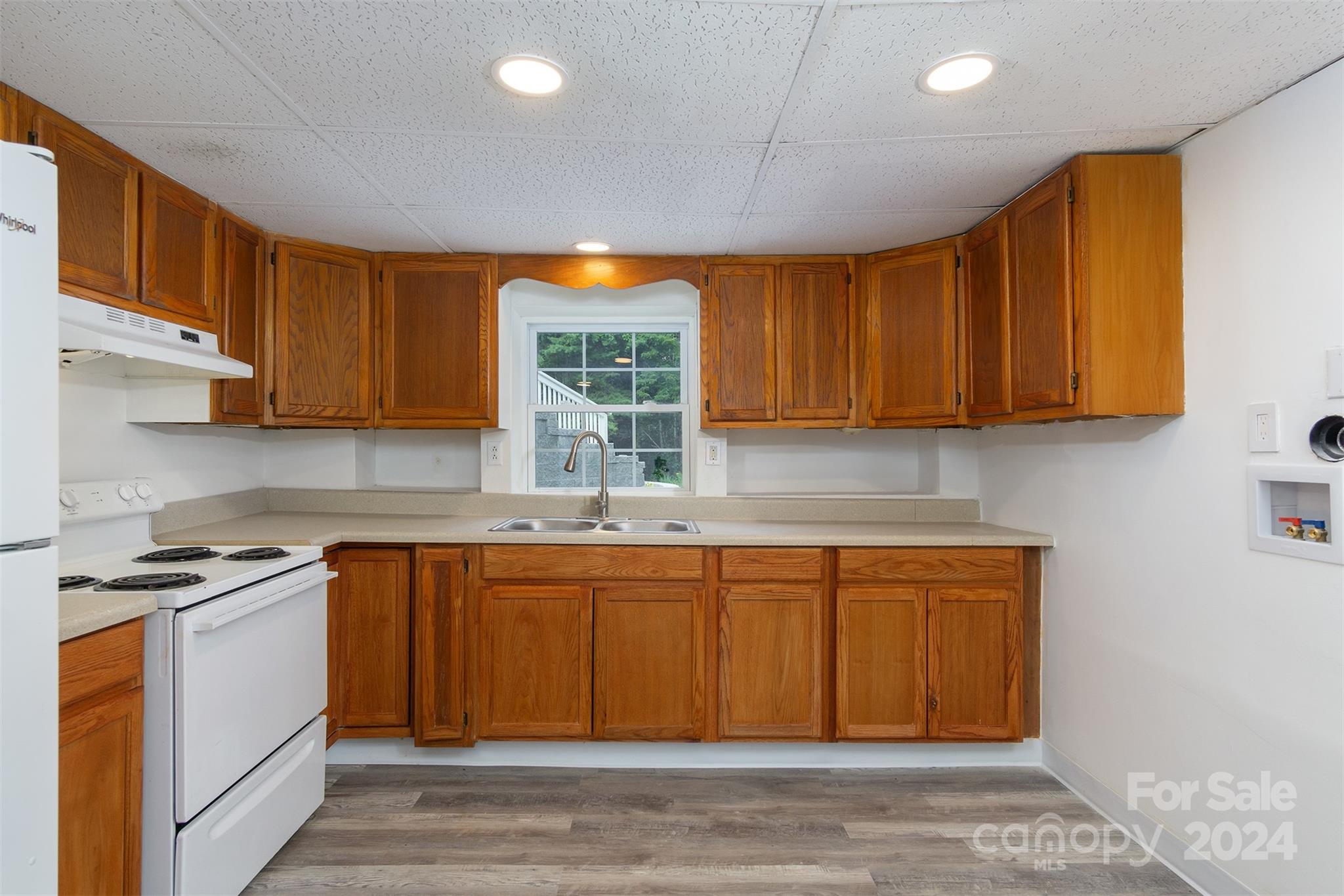 468 Deer Park Lake Road Spruce Pine, NC 28777 - Photo 37 of 46 a kitchen with stainless steel appliances granite countertop wooden cabinets a sink and dishwasher