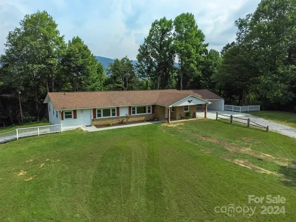 a aerial view of a house next to a big yard