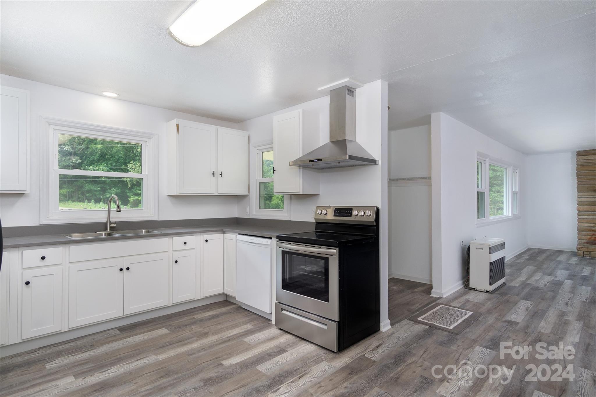 468 Deer Park Lake Road Spruce Pine, NC 28777 - Photo 7 of 46 a kitchen with stainless steel appliances granite countertop a sink and a stove
