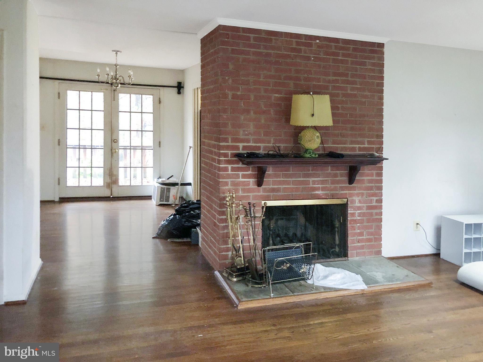 7202 Catlett Street Springfield, VA 22151 - Photo 7 of 28 a living room with furniture and a fireplace