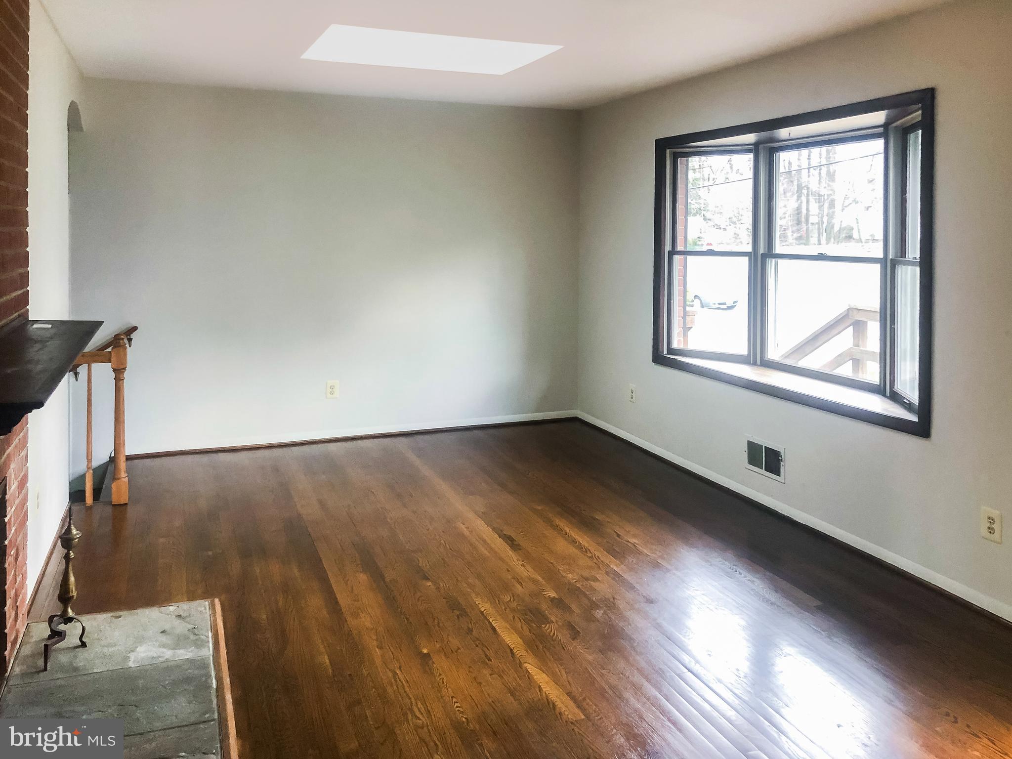 7202 Catlett Street Springfield, VA 22151 - Photo 9 of 28 an empty room with wooden floor and windows