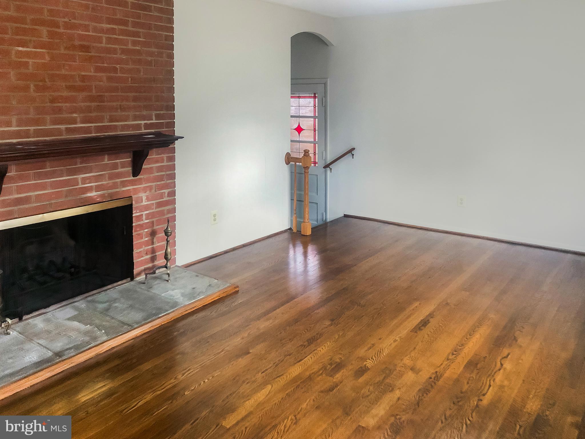 7202 Catlett Street Springfield, VA 22151 - Photo 10 of 28 a view of empty room with wooden floor and fireplace
