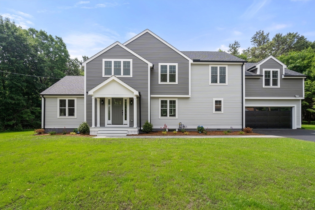32 Deerfield Road Sharon, MA 02067 - Photo 1 of 32 a front view of a house with a yard and garage
