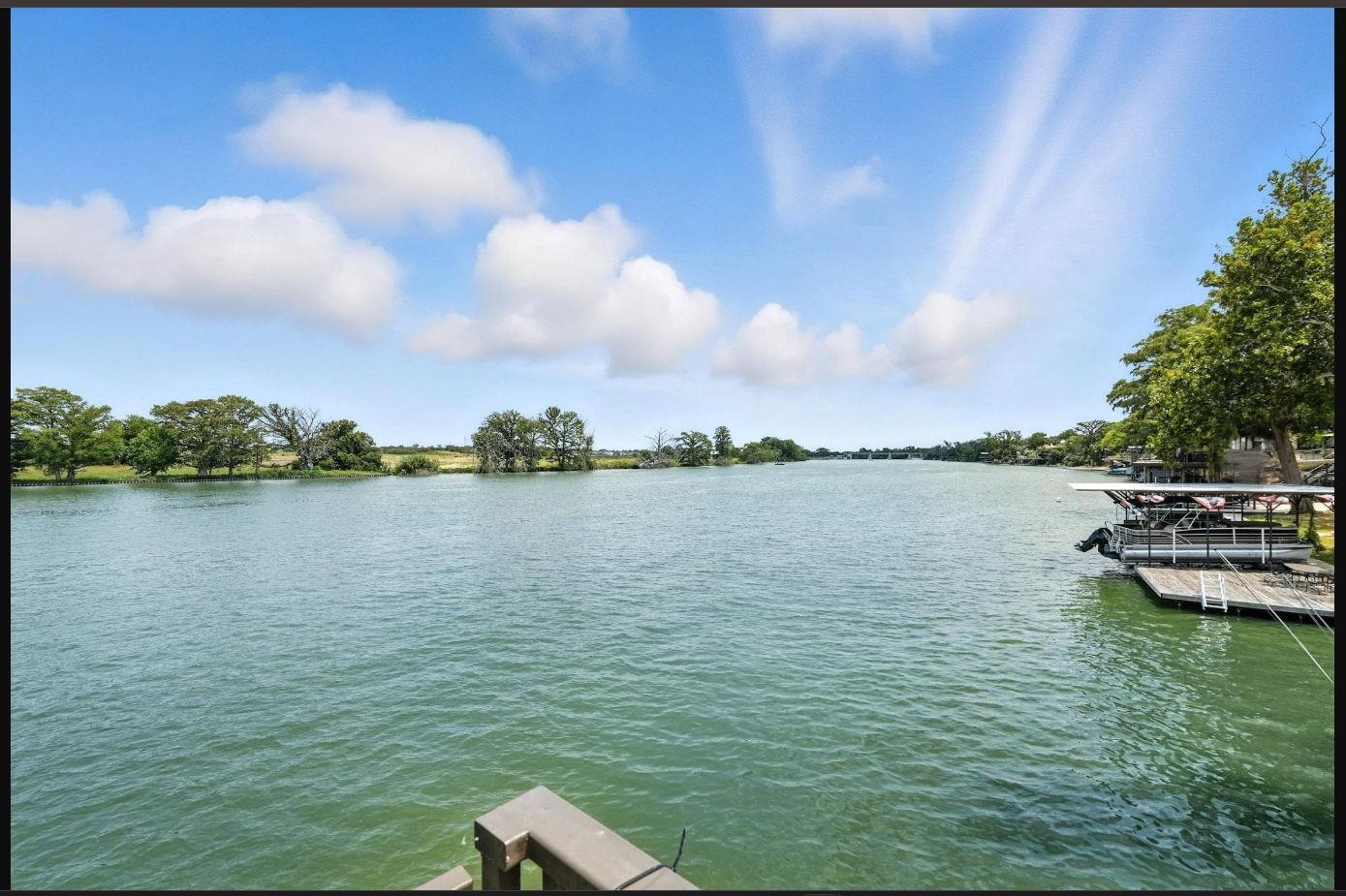 1435 East Zipp Road New Braunfels, TX 78130 - Photo 2 of 43 a view of a lake with houses in the back
