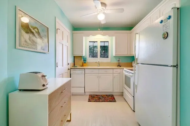 a kitchen with a refrigerator and a sink