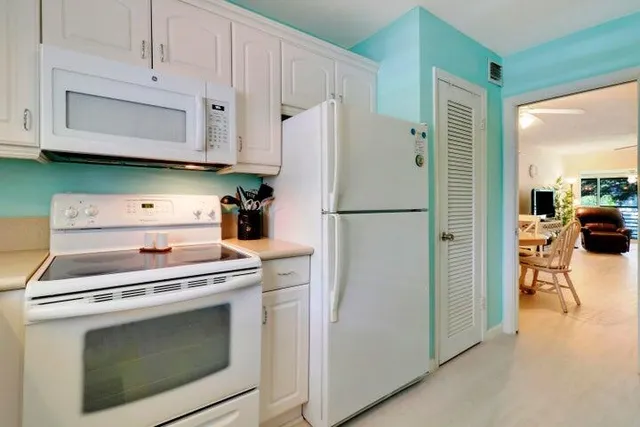 a kitchen with a stove and a refrigerator