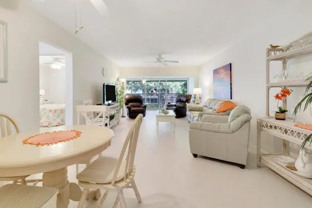 a living room with furniture a fireplace and a table