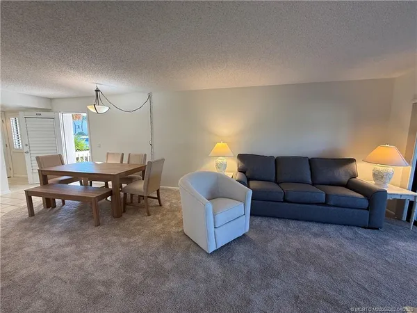 a living room with furniture and a lamp