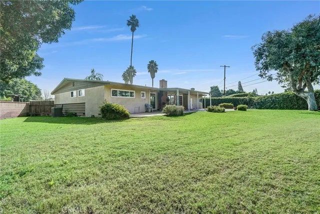 a view of a garden with a house in the background