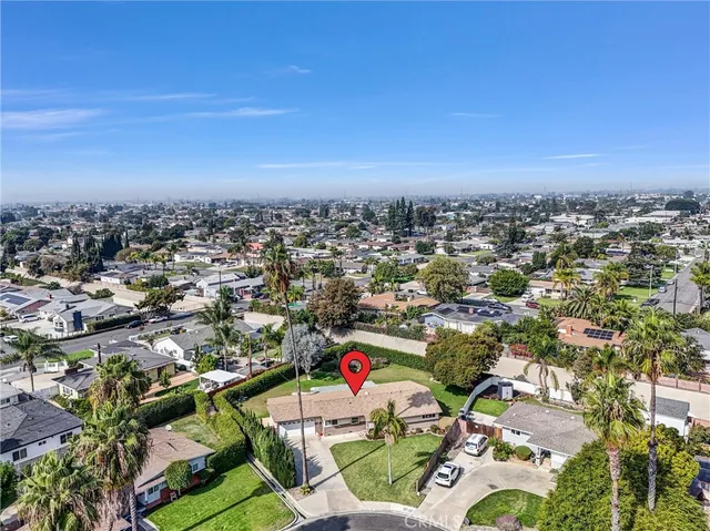an aerial view of a houses with a swimming pool