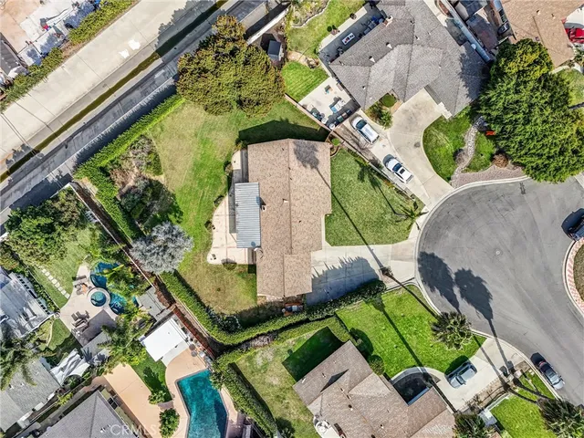 an aerial view of a house with a yard