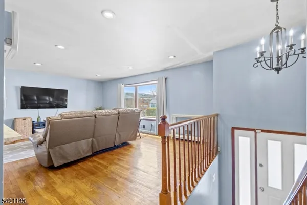 a living room with furniture a rug and a flat screen tv
