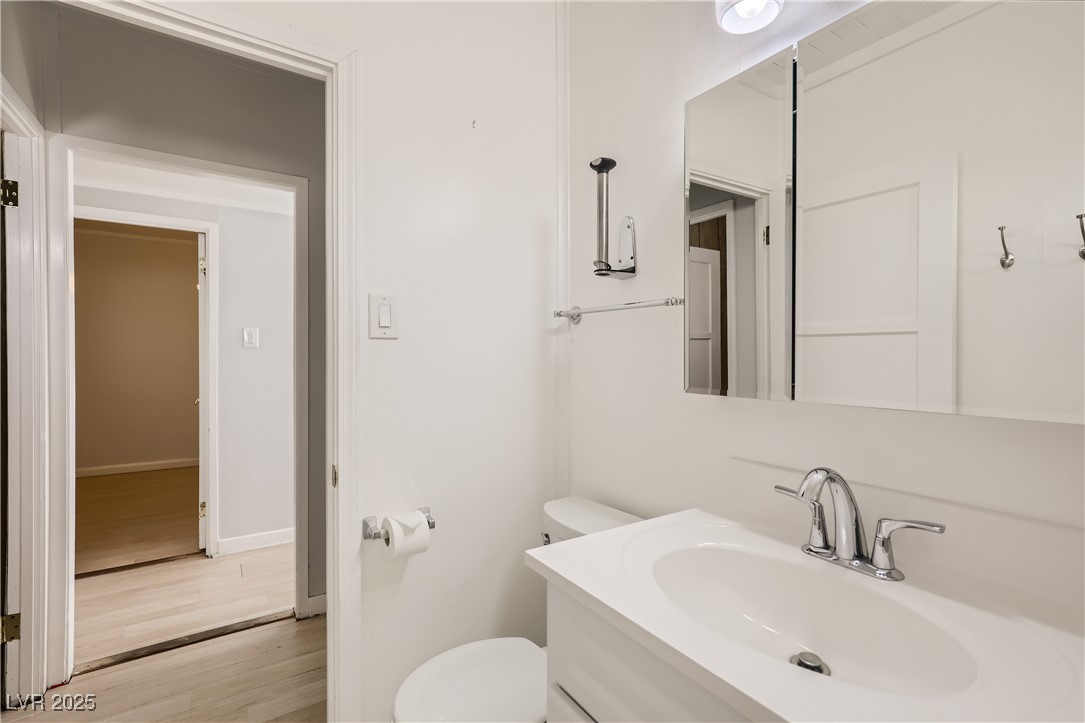 103 West Victory Road Henderson, NV 89015 - Photo 23 of 28 Bathroom featuring wood finished floors, toilet, v