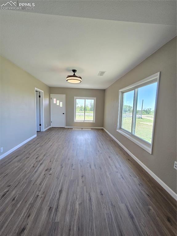 12350 Holtwood Road Simla, CO 80835 - Photo 13 of 34 an empty room with wooden floor and windows