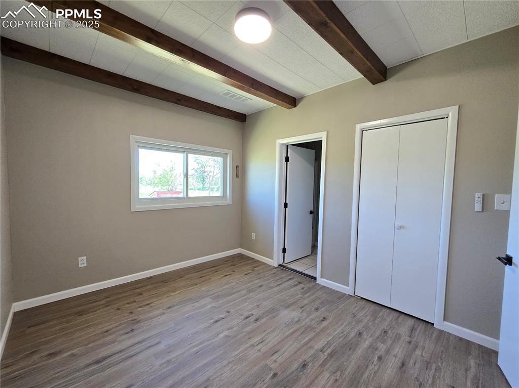 12350 Holtwood Road Simla, CO 80835 - Photo 16 of 34 a view of an empty room with wooden floor and a window