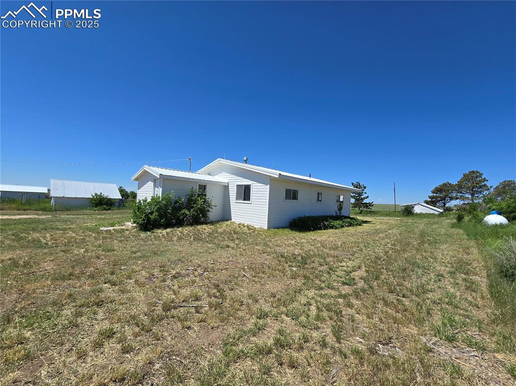 12350 Holtwood Road Simla, CO 80835 - Photo 22 of 34 a view of a house with a yard