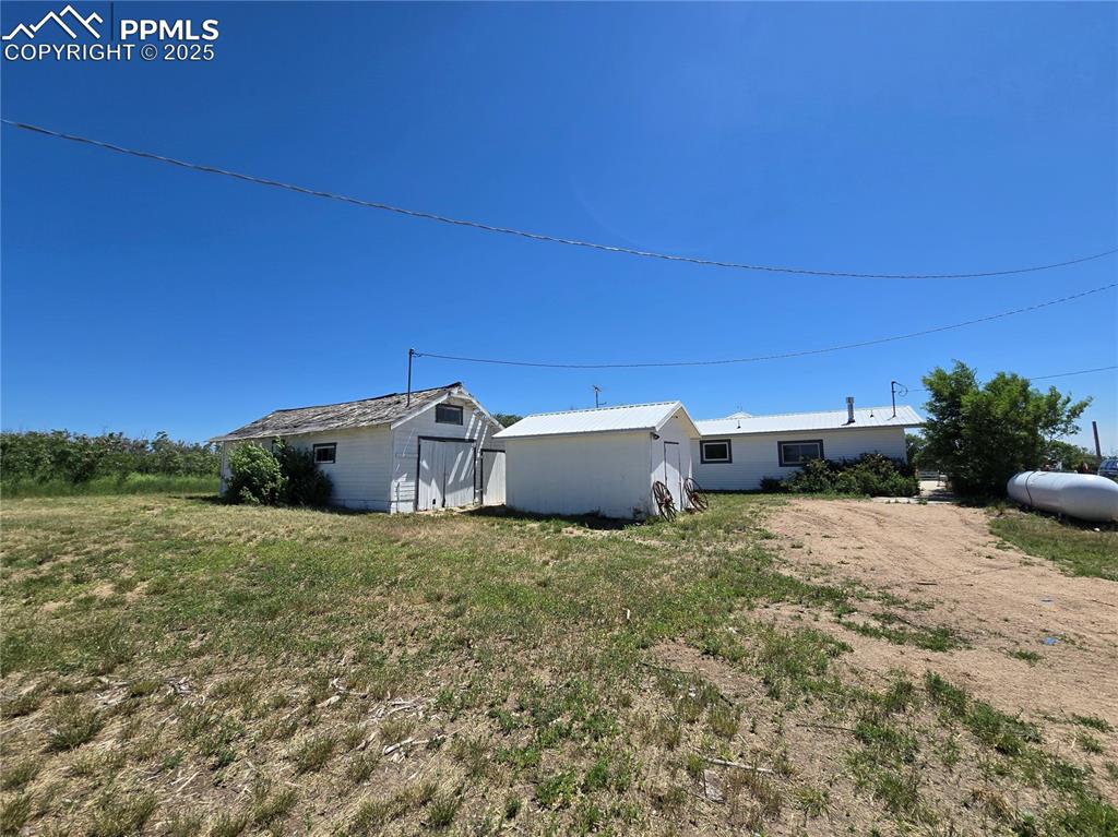 12350 Holtwood Road Simla, CO 80835 - Photo 23 of 34 a backyard of a house with a yard and garage
