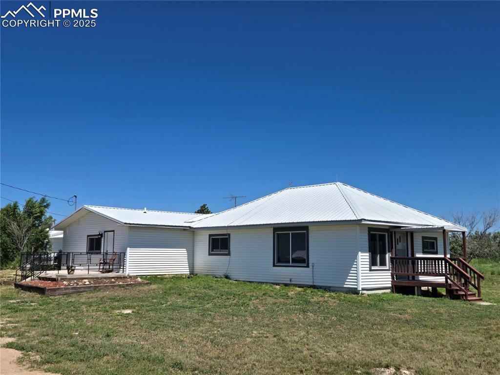 12350 Holtwood Road Simla, CO 80835 - Photo 3 of 34 a front view of a house with a yard