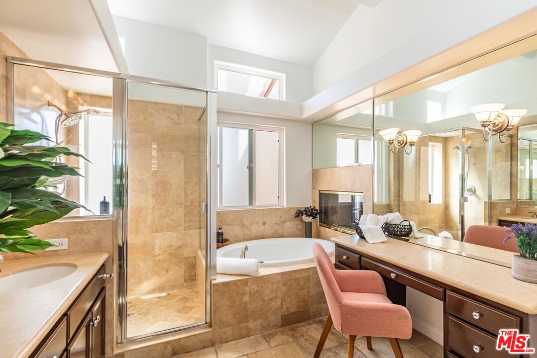 6438 Lunita Road Malibu, CA 90265 - Photo 28 of 34 a bathroom with a granite countertop tub sink and mirror