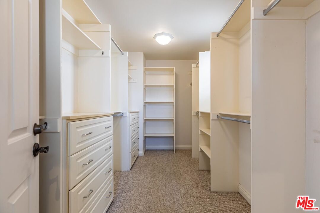 6438 Lunita Road Malibu, CA 90265 - Photo 30 of 34 a view of walk in closet with empty racks