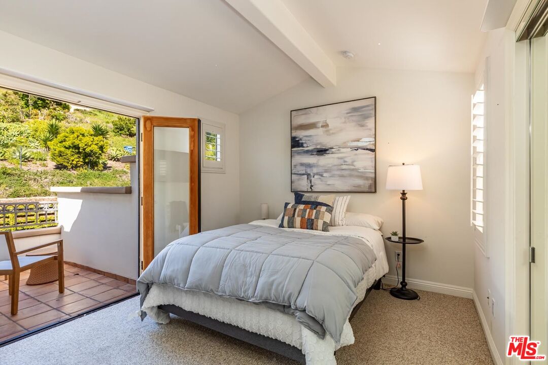 6438 Lunita Road Malibu, CA 90265 - Photo 32 of 34 a bedroom with a bed and a window