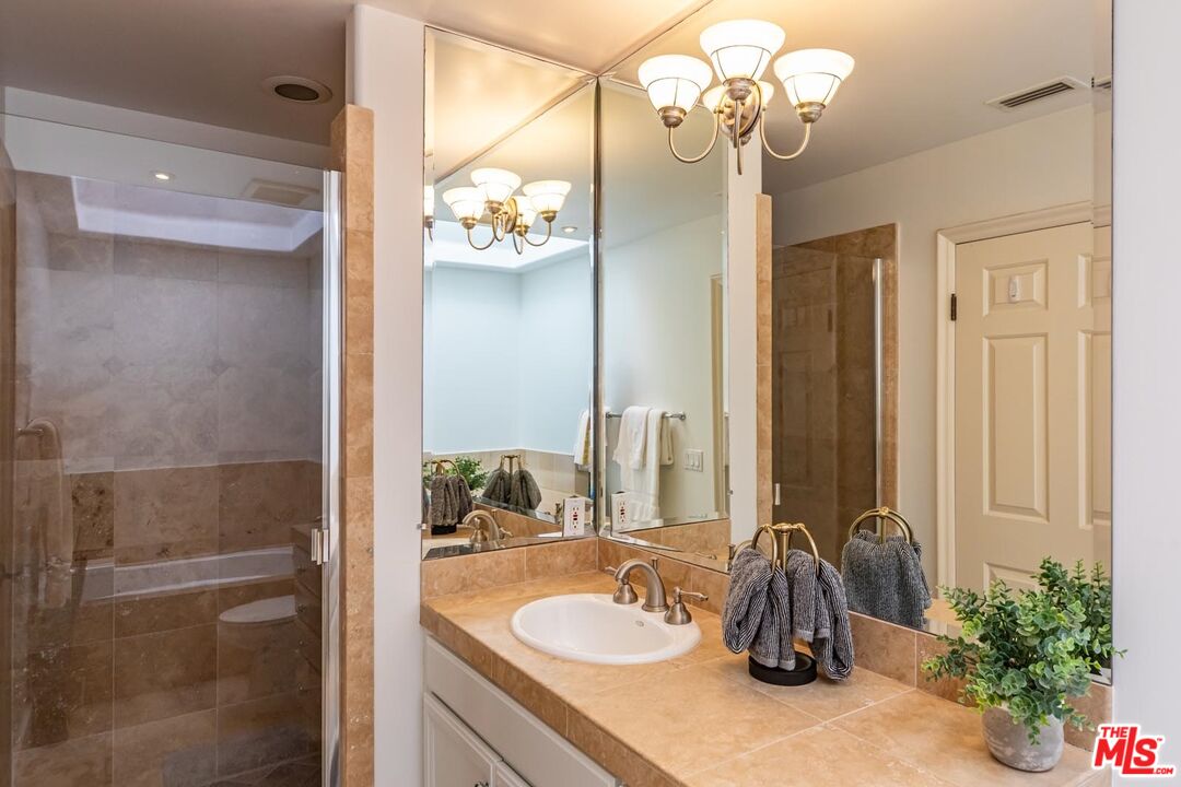 6438 Lunita Road Malibu, CA 90265 - Photo 34 of 34 a bathroom with a sink a mirror and a shower