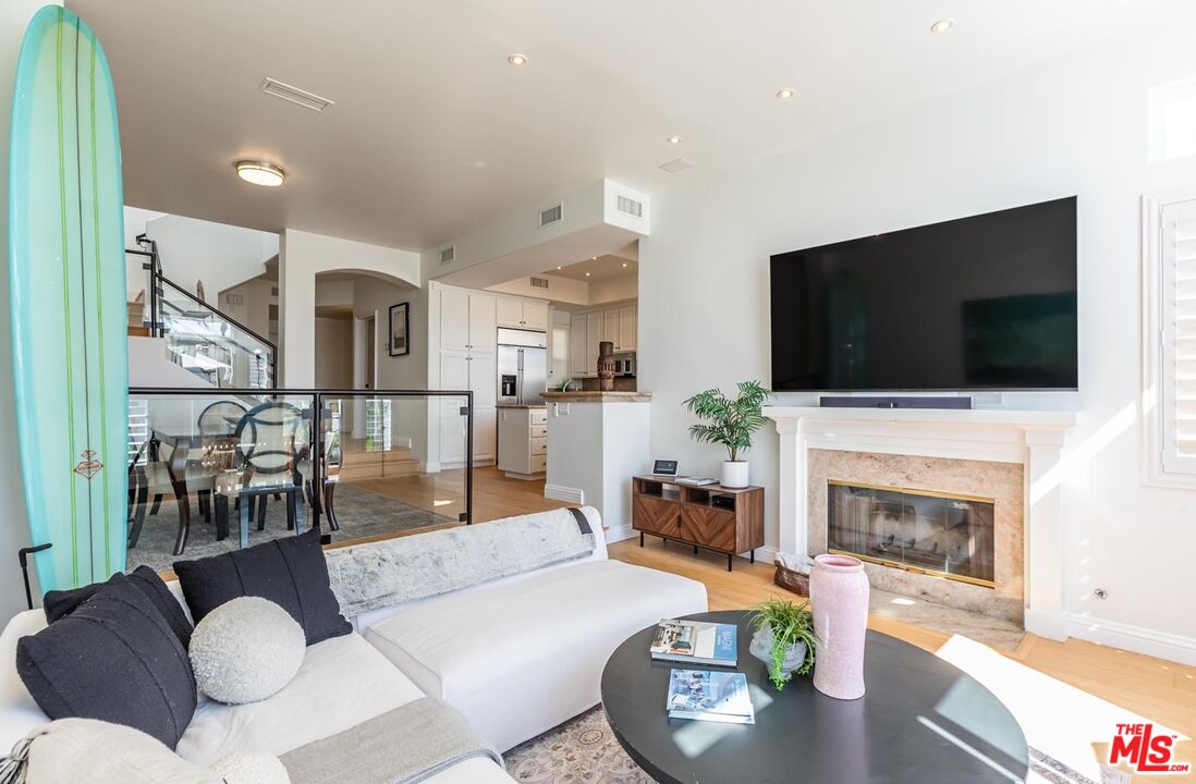 6438 Lunita Road Malibu, CA 90265 - Photo 6 of 34 a living room with furniture a flat screen tv and a fireplace