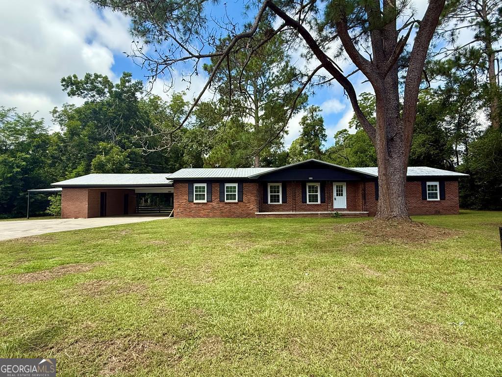 808 Laurel Avenue Adel, GA 31620 - Photo 1 of 1 a front view of a house with a garden