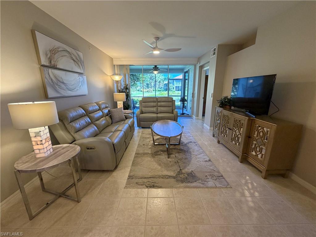 23810 Marbella Bay Road, Unit 102 Estero, FL 34135 - Photo 11 of 26 a living room with furniture and a flat screen tv
