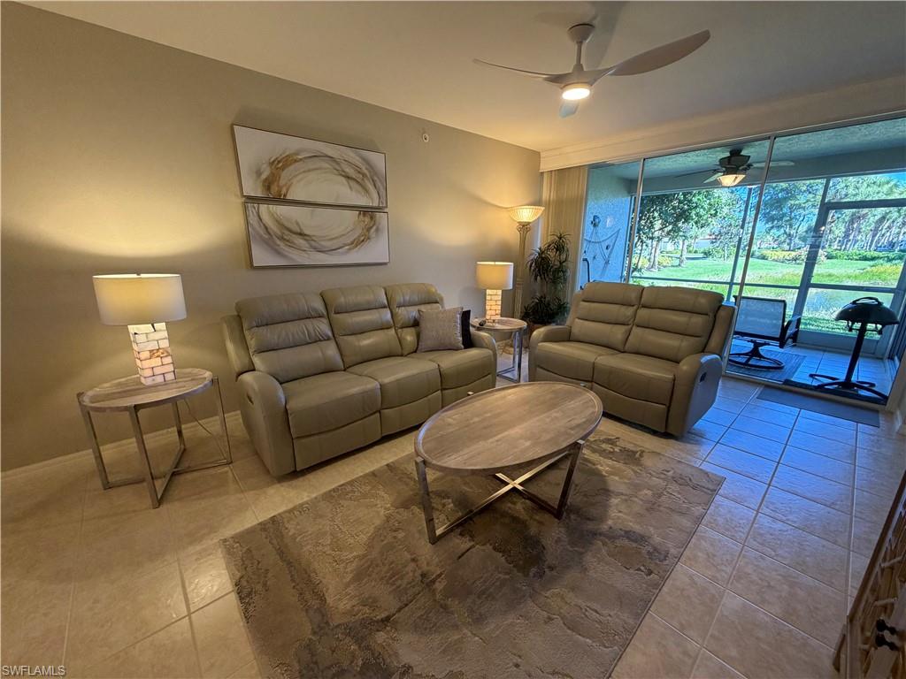 23810 Marbella Bay Road, Unit 102 Estero, FL 34135 - Photo 13 of 26 a living room with furniture and a large window