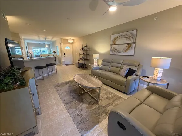 a living room with furniture and a lamp