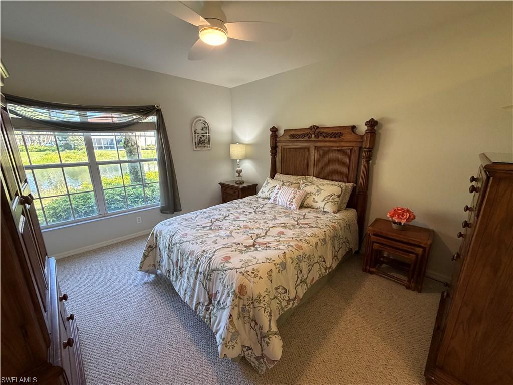23810 Marbella Bay Road, Unit 102 Estero, FL 34135 - Photo 16 of 26 a bed sitting in a bedroom next to a window