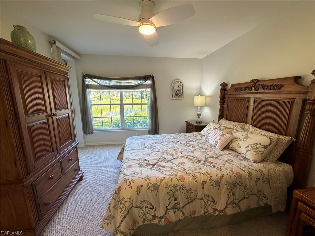 23810 Marbella Bay Road, Unit 102 Estero, FL 34135 - Photo 17 of 26 a bed sitting in a bedroom next to a window
