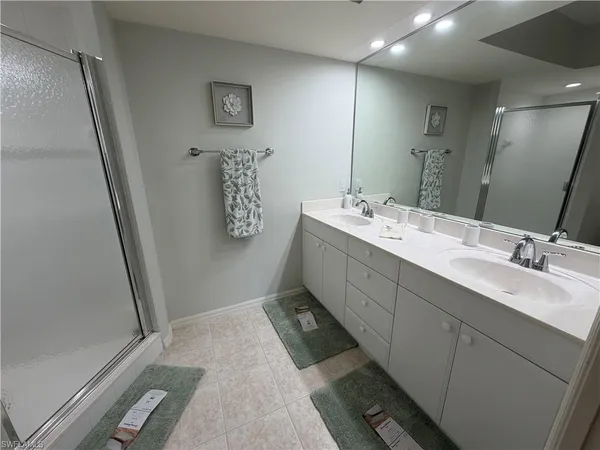a bathroom with a double vanity sink and mirror