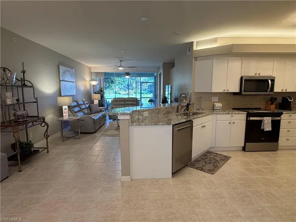 a kitchen with a sink cabinets and window