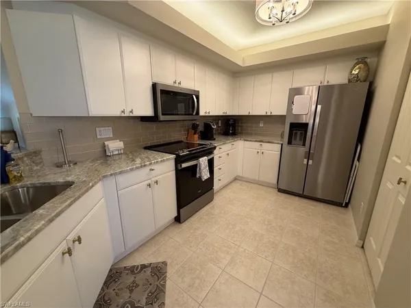 a kitchen with a sink cabinets and appliances