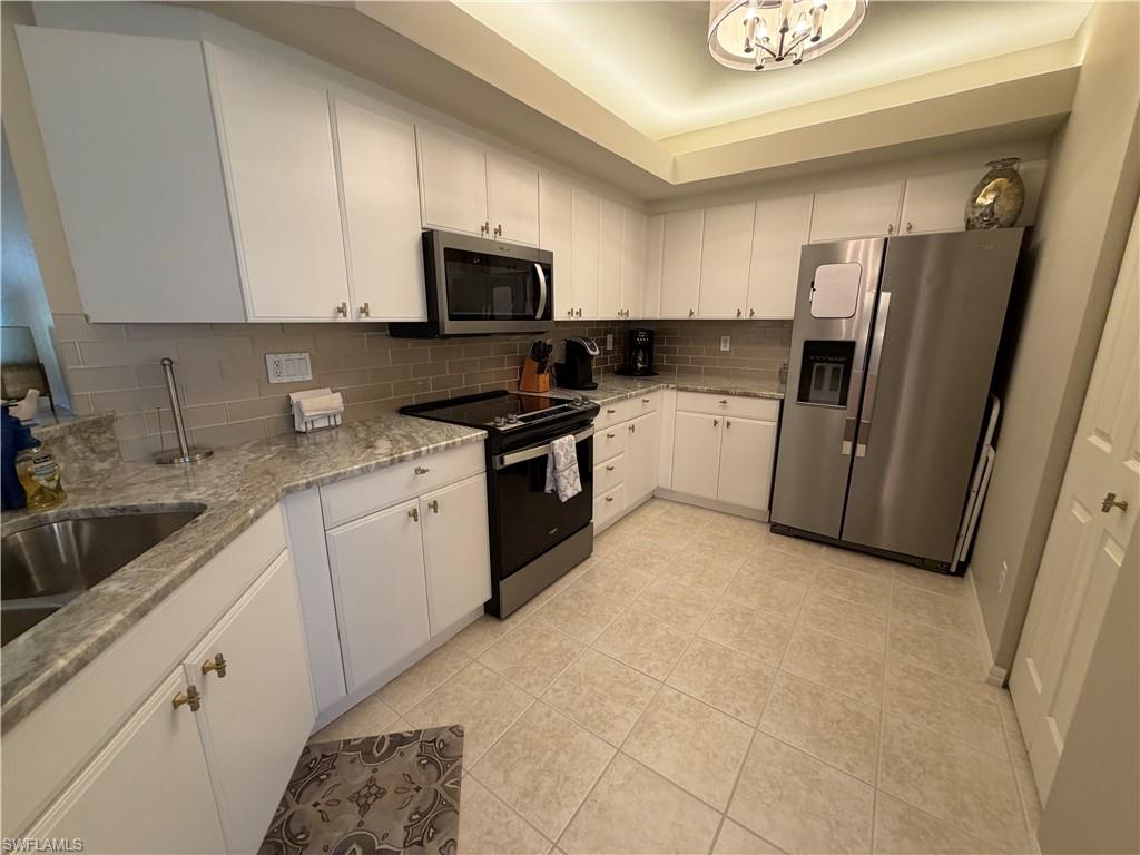 23810 Marbella Bay Road, Unit 102 Estero, FL 34135 - Photo 6 of 26 a kitchen with a sink cabinets and appliances