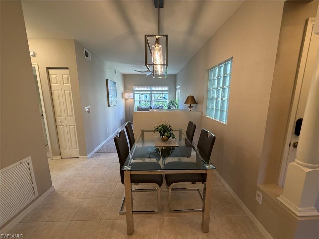 23810 Marbella Bay Road, Unit 102 Estero, FL 34135 - Photo 9 of 26 a view of a dining room with furniture window and wooden floor