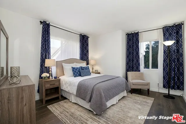 a bedroom with a bed and a mirror