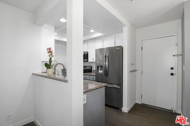 a kitchen with a refrigerator and cabinets