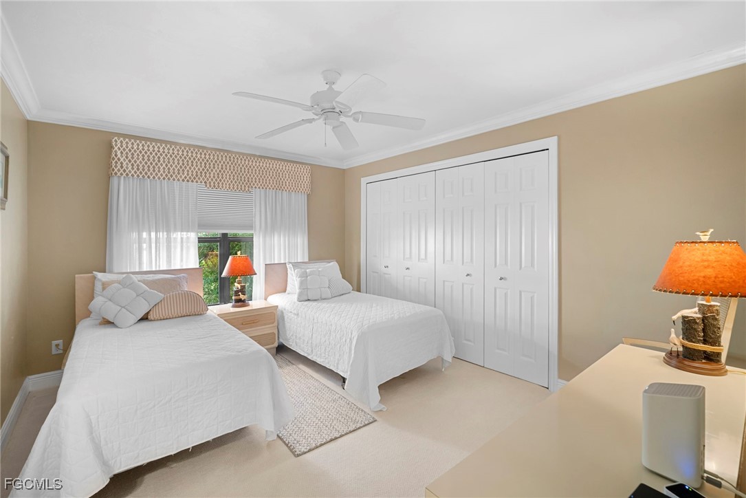 5688 Arvine Circle Fort Myers, FL 33919 - Photo 14 of 39 a bedroom with a bed and a chandelier