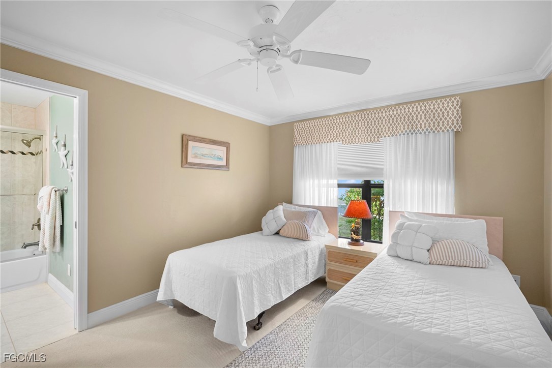 5688 Arvine Circle Fort Myers, FL 33919 - Photo 15 of 39 a bedroom with bed and a chandelier