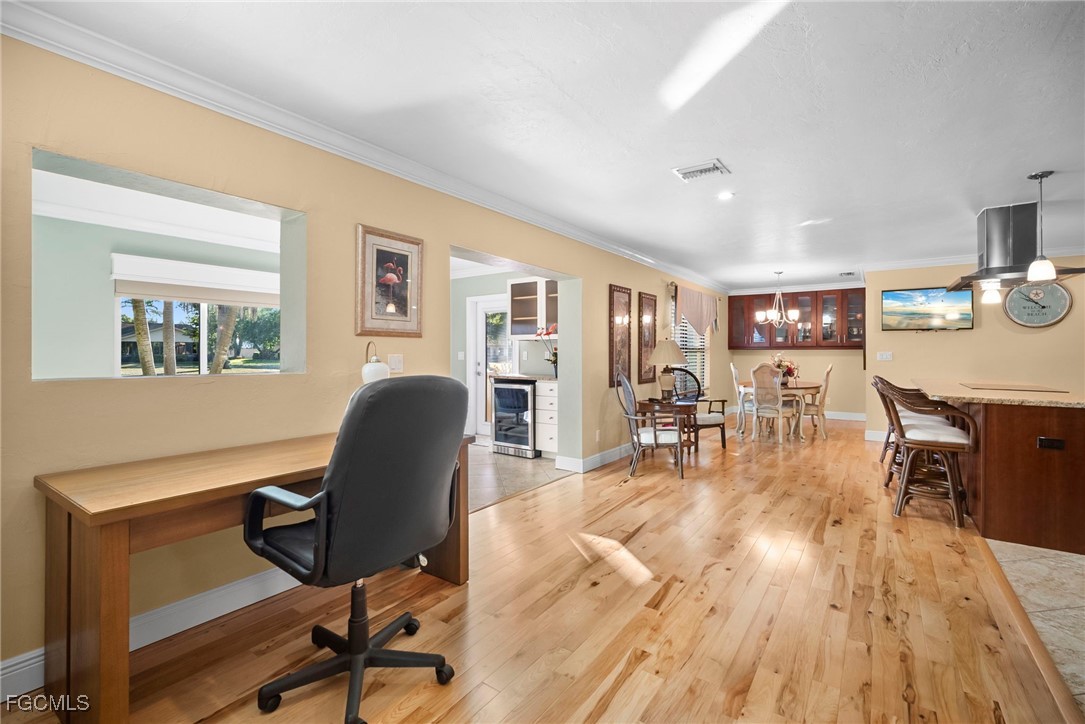 5688 Arvine Circle Fort Myers, FL 33919 - Photo 17 of 39 a workspace with furniture a book and wooden floor