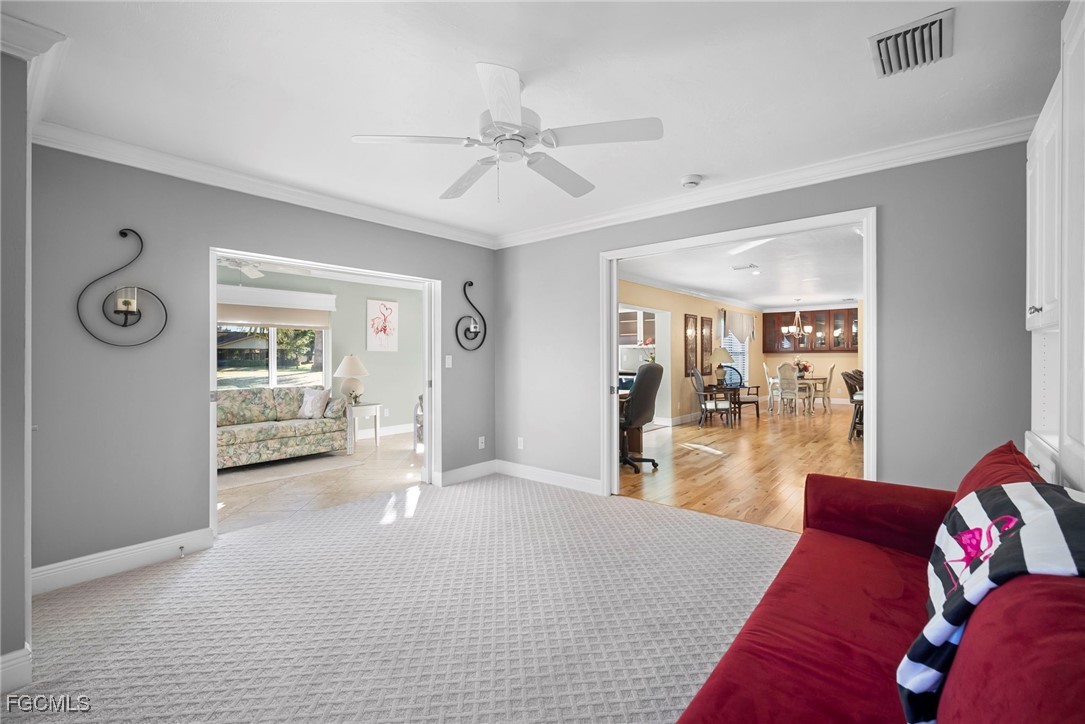5688 Arvine Circle Fort Myers, FL 33919 - Photo 21 of 39 a living room with furniture and a chandelier