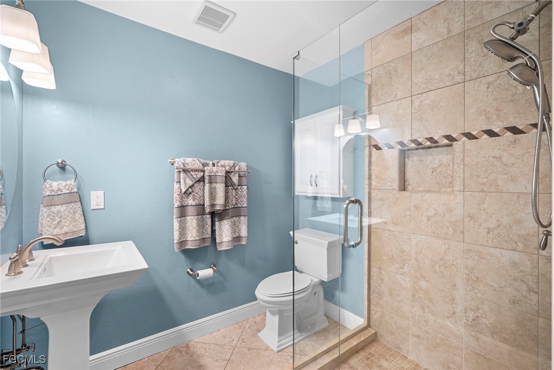 5688 Arvine Circle Fort Myers, FL 33919 - Photo 24 of 39 a bathroom with a toilet sink and shower
