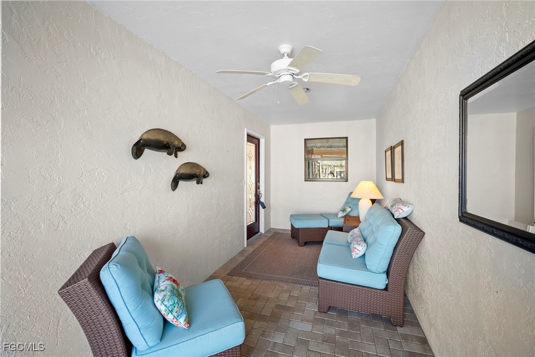 5688 Arvine Circle Fort Myers, FL 33919 - Photo 35 of 39 a living room with furniture and a potted plant